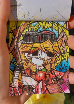 This is a photo of me holding up the drawing of Fisherman Grian